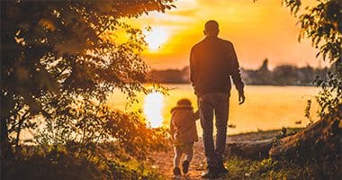 man and child sunset