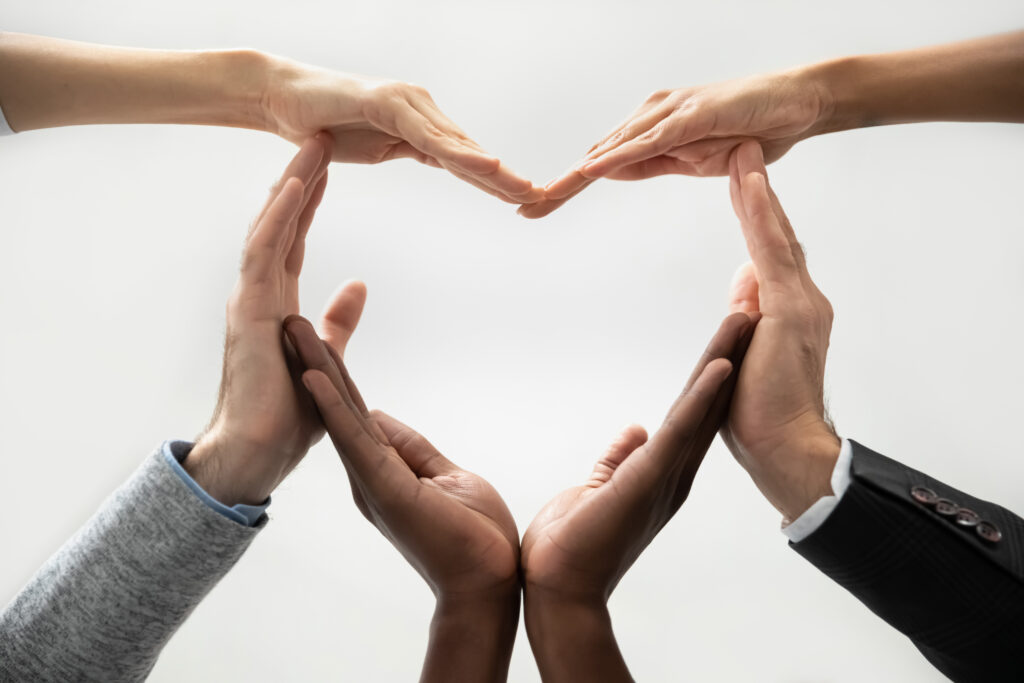 Multiracial people making heart out of hands