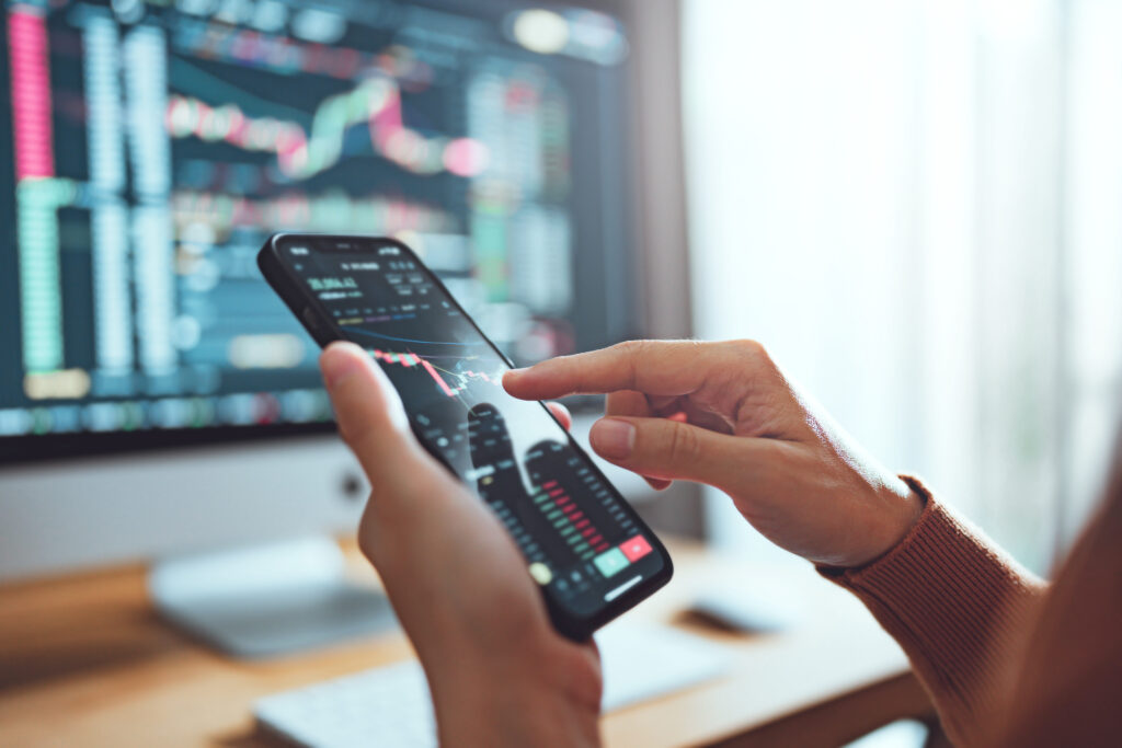 Woman is checking Bitcoin price chart on digital exchange on smartphone, cryptocurrency future price action prediction